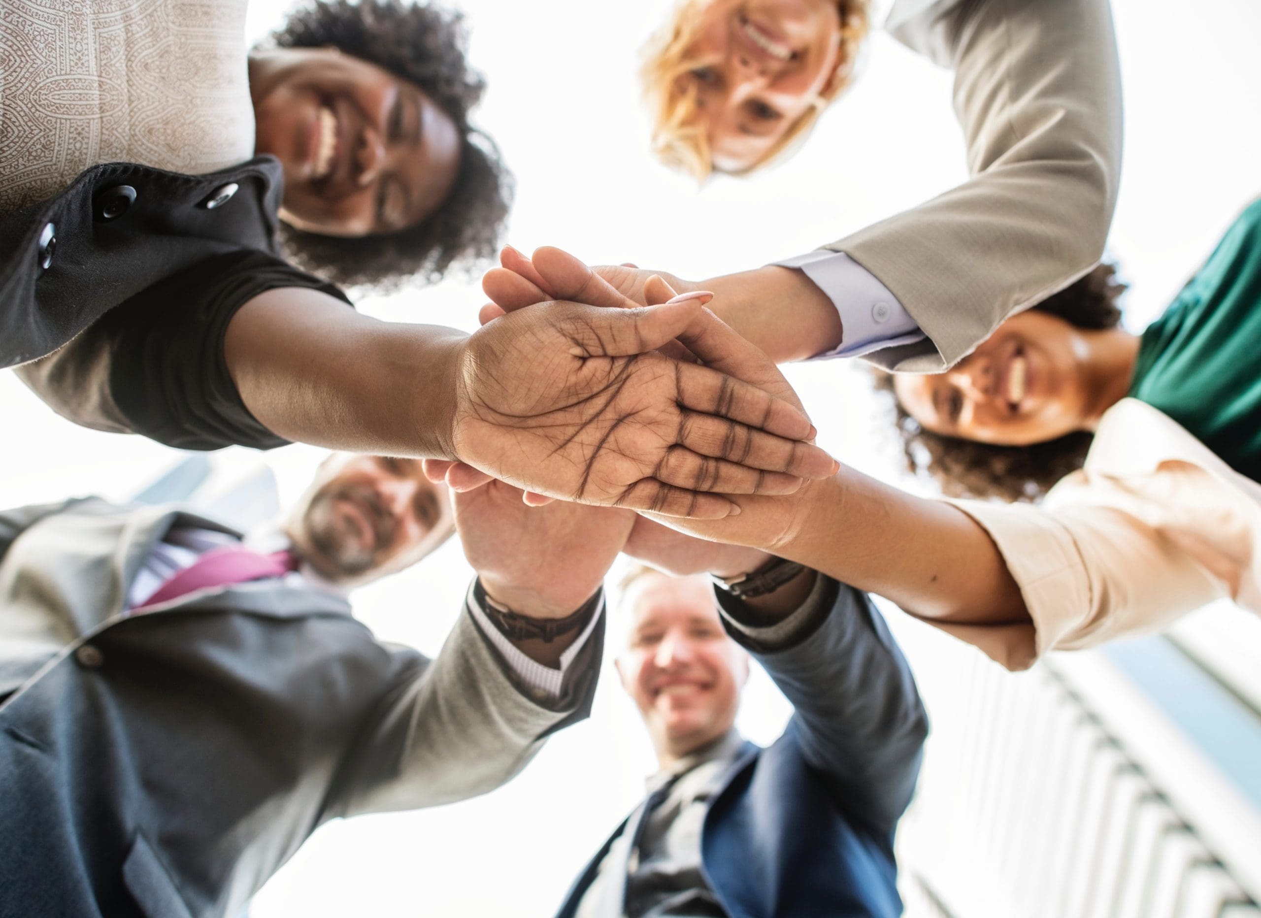 adult business people with hands in circle